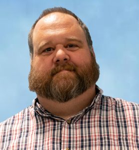 Charles McCrea - bearded man in plaid shirt