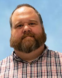 Charles McCrea - bearded man in plaid shirt